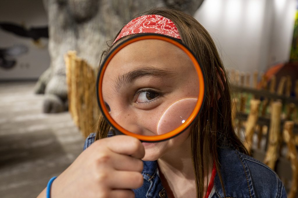 Girl with magnifying glass.